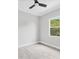 Cozy bedroom featuring a ceiling fan, window, and light gray flooring at 123 Ferdon Cir, Port Charlotte, FL 33954