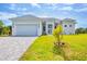 Beautiful single-Gathering home featuring a two-car garage, manicured lawn, and a gray brick driveway at 123 Ferdon Cir, Port Charlotte, FL 33954