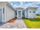 Welcoming front entrance with a paved walkway, complemented by colorful landscaping at 123 Ferdon Cir, Port Charlotte, FL 33954