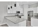 Open kitchen with granite countertops, modern appliances, and a center island for meal preparation at 123 Ferdon Cir, Port Charlotte, FL 33954