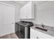 Laundry room featuring a washer, dryer, sink and cabinets at 123 Ferdon Cir, Port Charlotte, FL 33954
