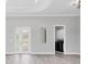 Bright and airy living room with elegant flooring and access to a laundry room at 123 Ferdon Cir, Port Charlotte, FL 33954