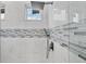 Modern shower featuring rainfall shower head, mosaic tile and a frameless glass enclosure at 123 Ferdon Cir, Port Charlotte, FL 33954