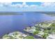 Wide aerial view of several waterfront homes situated on canals with easy access to open water at 12438 Prather Ave, Port Charlotte, FL 33981