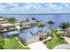 Expansive waterfront home boasts lush landscaping, a private boat dock, and stunning river views at 12438 Prather Ave, Port Charlotte, FL 33981