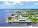 Aerial view of gorgeous waterfront estate with dock, boathouse, pool, and meticulously landscaped grounds at 12438 Prather Ave, Port Charlotte, FL 33981