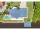 Stunning aerial view of estate home with boat dock, boat house, pool, metal roof, and lush landscaping at 12438 Prather Ave, Port Charlotte, FL 33981