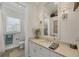 Bright bathroom with vanity, stylish mirror, sconces, and updated fixtures at 12438 Prather Ave, Port Charlotte, FL 33981