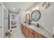 Spacious bathroom with granite countertops, dual sinks, decorative mirrors, and calming decor at 12438 Prather Ave, Port Charlotte, FL 33981