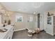 A well-lit bathroom featuring a modern shower with glass enclosure, white cabinetry and stylish fixtures at 12438 Prather Ave, Port Charlotte, FL 33981