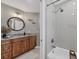 Bathroom featuring a wooden vanity with granite countertops, shower, and tile flooring at 12438 Prather Ave, Port Charlotte, FL 33981