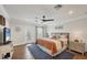 Cozy bedroom with hardwood flooring, ceiling fan, and ample natural light, creating a welcoming atmosphere at 12438 Prather Ave, Port Charlotte, FL 33981