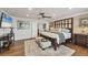 Comfortable bedroom with hardwood floors, ceiling fan, and decorative touches, offering a relaxing retreat at 12438 Prather Ave, Port Charlotte, FL 33981