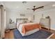 Bright bedroom featuring a ceiling fan, hardwood floors, and a comfortable bed, perfect for relaxation at 12438 Prather Ave, Port Charlotte, FL 33981
