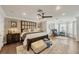 This spacious bedroom features hardwood floors, a ceiling fan, and a cozy sitting area by the window at 12438 Prather Ave, Port Charlotte, FL 33981