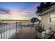 Outdoor deck with comfortable seating area offering serene water views at sunset at 12438 Prather Ave, Port Charlotte, FL 33981