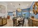 An open concept dining room with tile floors, a decorative light fixture, and seating for eight at 12438 Prather Ave, Port Charlotte, FL 33981
