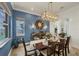 The dining room has blue walls, decor lighting, and a water view at 12438 Prather Ave, Port Charlotte, FL 33981