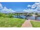 The property has a private boat dock featuring a covered area, offering convenient waterfront access and storage at 12438 Prather Ave, Port Charlotte, FL 33981