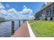 The dock extends to the water, offering convenient access and enhancing the waterfront living experience at 12438 Prather Ave, Port Charlotte, FL 33981