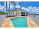 The house offers a private pool, lush landscaping, and outdoor seating perfect for enjoying the waterfront lifestyle at 12438 Prather Ave, Port Charlotte, FL 33981