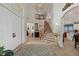 Spacious two-story foyer features tile floors, staircase, and an open floor plan at 12438 Prather Ave, Port Charlotte, FL 33981