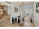 Bright foyer with travertine floors, elegant chandelier, and staircase to the second floor at 12438 Prather Ave, Port Charlotte, FL 33981