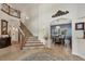 Grand foyer showcases a staircase, travertine floors, and an archway to the formal dining room at 12438 Prather Ave, Port Charlotte, FL 33981