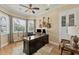 Spacious home office with a large desk, built-in cabinets, and hardwood floors at 12438 Prather Ave, Port Charlotte, FL 33981