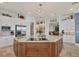 Gourmet kitchen with a large island, stone countertops, stainless appliances, and views into the bar at 12438 Prather Ave, Port Charlotte, FL 33981