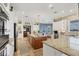 Open concept kitchen with a large center island, stainless appliances, and views of the dining and living areas at 12438 Prather Ave, Port Charlotte, FL 33981