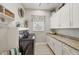 Functional laundry room with granite countertops, white cabinets, and washer/dryer at 12438 Prather Ave, Port Charlotte, FL 33981