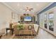 Living room featuring a large entertainment center and access to the rear screened patio at 12438 Prather Ave, Port Charlotte, FL 33981
