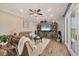 Spacious living room with an entertainment center and access to the screened patio at 12438 Prather Ave, Port Charlotte, FL 33981