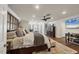 Bright main bedroom with a ceiling fan, sitting area and TV at 12438 Prather Ave, Port Charlotte, FL 33981