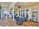 Covered outdoor patio with stylish furniture, tile flooring, ceiling fan, and beautiful lighting at 12438 Prather Ave, Port Charlotte, FL 33981