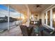 Covered outdoor patio with comfortable seating and views of the canal and sunset at 12438 Prather Ave, Port Charlotte, FL 33981