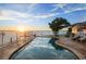 Beautiful backyard pool overlooking the waterfront at sunset at 12438 Prather Ave, Port Charlotte, FL 33981