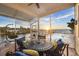 Covered porch with ample seating overlooking the pool and waterway at sunset at 12438 Prather Ave, Port Charlotte, FL 33981