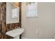 Stylish powder room with wood accent wall, sink and vanity at 12438 Prather Ave, Port Charlotte, FL 33981