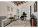 Cozy sitting room features a wood-paneled ceiling, piano, and lots of natural light at 12438 Prather Ave, Port Charlotte, FL 33981