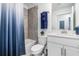 Bright bathroom with a shower and bath tub combination, white vanity and tiled walls at 12550 Galapagos Ct # 104, Venice, FL 34293