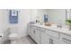 Bathroom features a double vanity, modern fixtures, and stylish decor at 12550 Galapagos Ct # 104, Venice, FL 34293