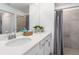 Bathroom features a double vanity, modern fixtures, and a glass-enclosed shower at 12550 Galapagos Ct # 104, Venice, FL 34293