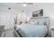 Bright bedroom with a ceiling fan, a painting and access to the bathroom at 12550 Galapagos Ct # 104, Venice, FL 34293