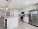 Contemporary kitchen with island seating and stainless steel fridge at 12550 Galapagos Ct # 104, Venice, FL 34293