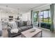 Comfortable living room with sliding glass doors and kitchen view at 12550 Galapagos Ct # 104, Venice, FL 34293