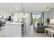 Bright open-concept living space with kitchen and golf course views at 12550 Galapagos Ct # 104, Venice, FL 34293
