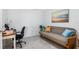 Well-lit office area with a sofa bed, desk, and a calming beach themed painting at 12550 Galapagos Ct # 104, Venice, FL 34293