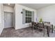 Private patio with dining set and stylish outdoor decor at 12550 Galapagos Ct # 104, Venice, FL 34293